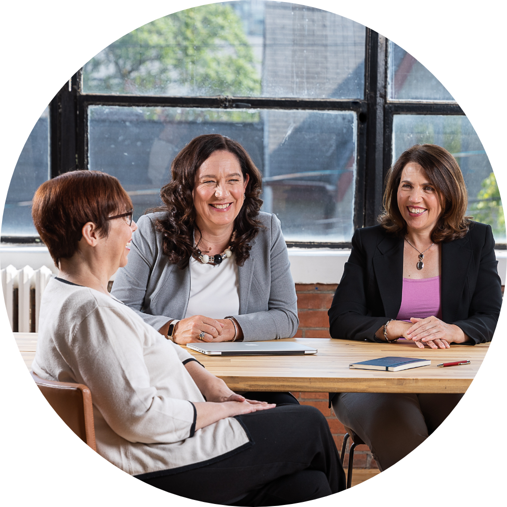 3 women laughing and collaborating